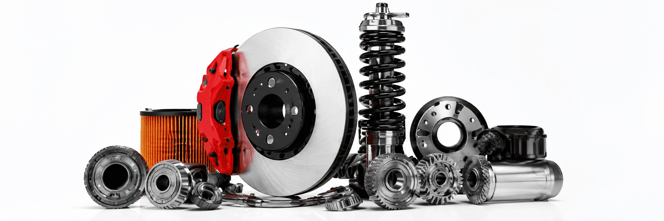 An assortment of auto parts - brake rotor and caliper, oil filter, shock absorber, gears, and bearings